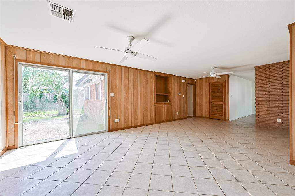 Sliding glass doors off family room leading to the backyard