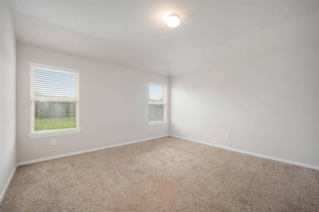 Primary bedroom with 2 windows letting in great natural light.