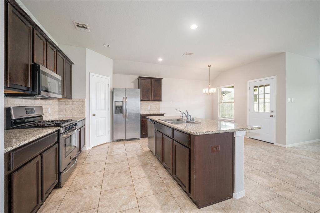 Beautiful, open kitchen with plenty of counter space as well as a walk in pantry.