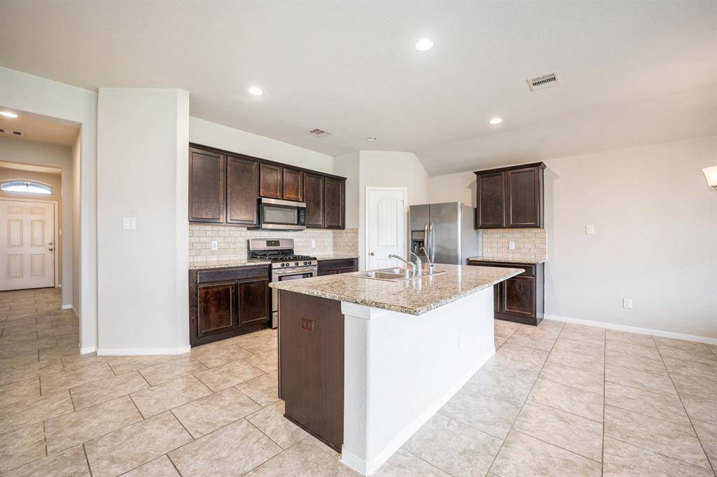 Kitchen island has room to add barstools for extra seating.