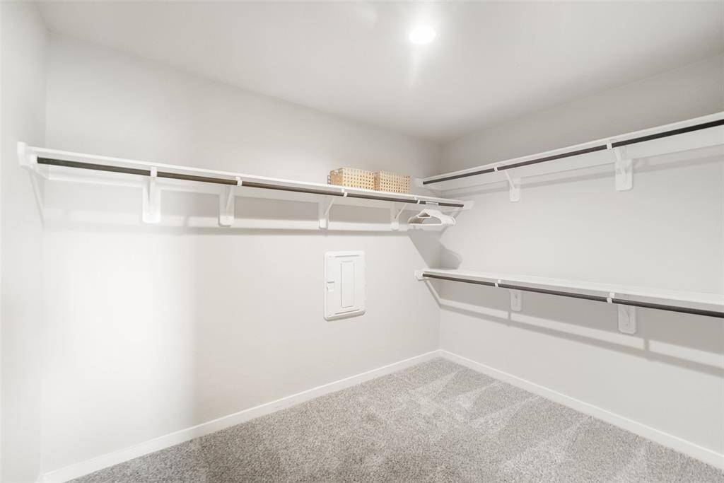 This spacious closet for the primary bedroom has plenty of room for sharing.