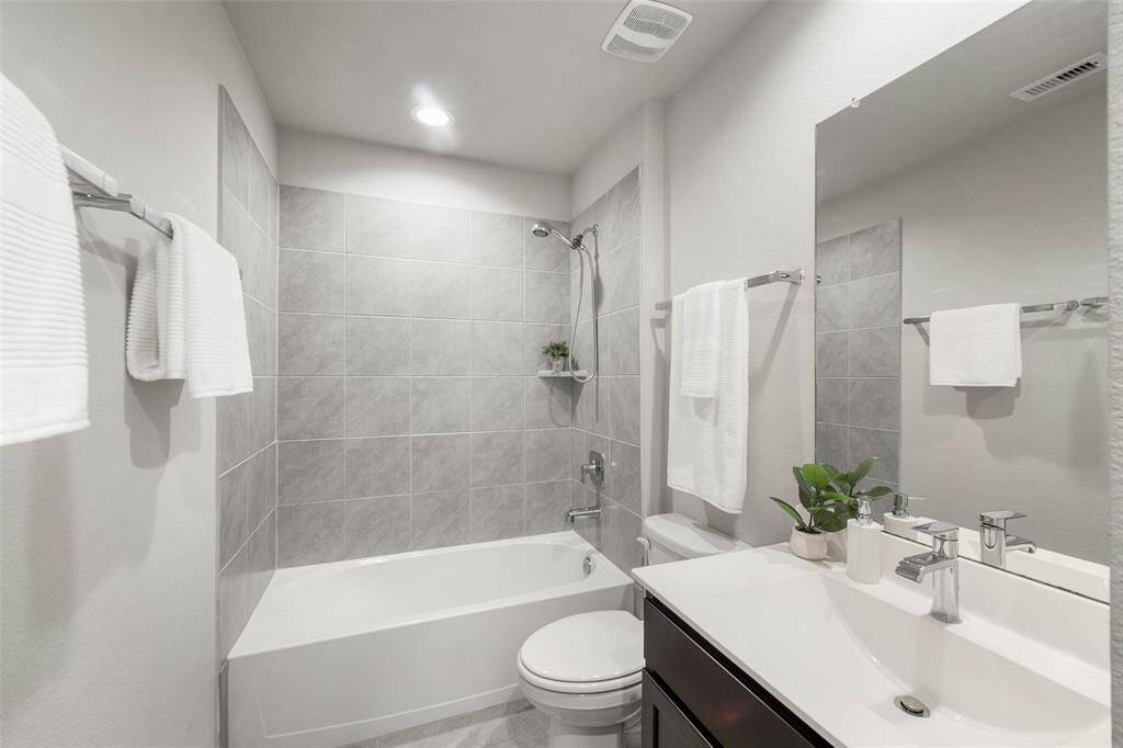 This pristine secondary bathroom is adjacent to the secondary bedrooms.  Not shown here are added custom cabinets, which provide significant storage for the room.