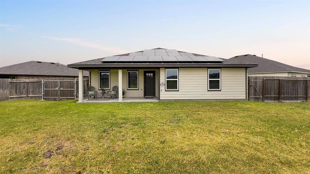 This view of the back of the home shows there's room for a garden, a trampoline, a play fort, or all three!  The double-wide gate at left was thoughtfully added by the sellers.