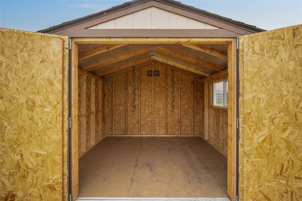 Double doors open to show an 8'X10' space. The roof and flooring were upgraded.