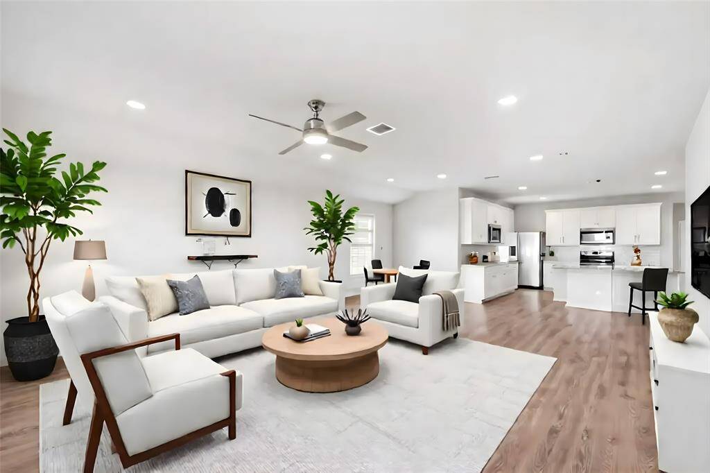 From this angle of this virtually-staged room, you can see the open concept kitchen at the far end.