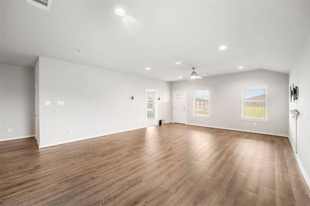 The room is a blank slate that is waiting for your creativity.  Once you add your furniture, this will be a much-loved gathering place within the home. The doorway straight ahead leads to the primary bedroom suite.