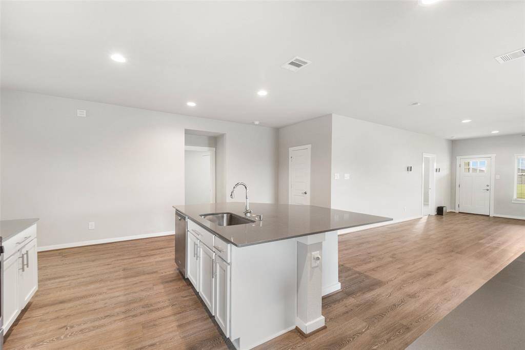 There's room at the island for chairs or stools for a breakfast bar.  The deep stainless-steel sink at the island  includes an upgraded disposal!