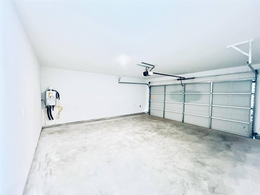 Garge includes tankless water heater and garage door opener.