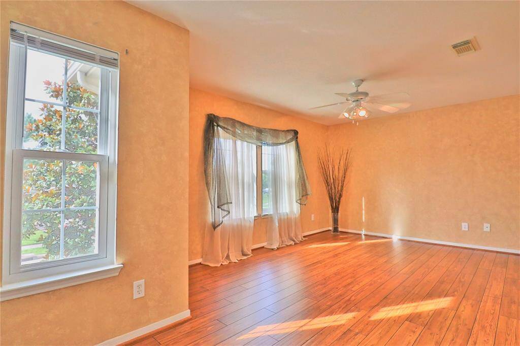 Bright and inviting  game room Features large windows for natural light, a ceiling fan.