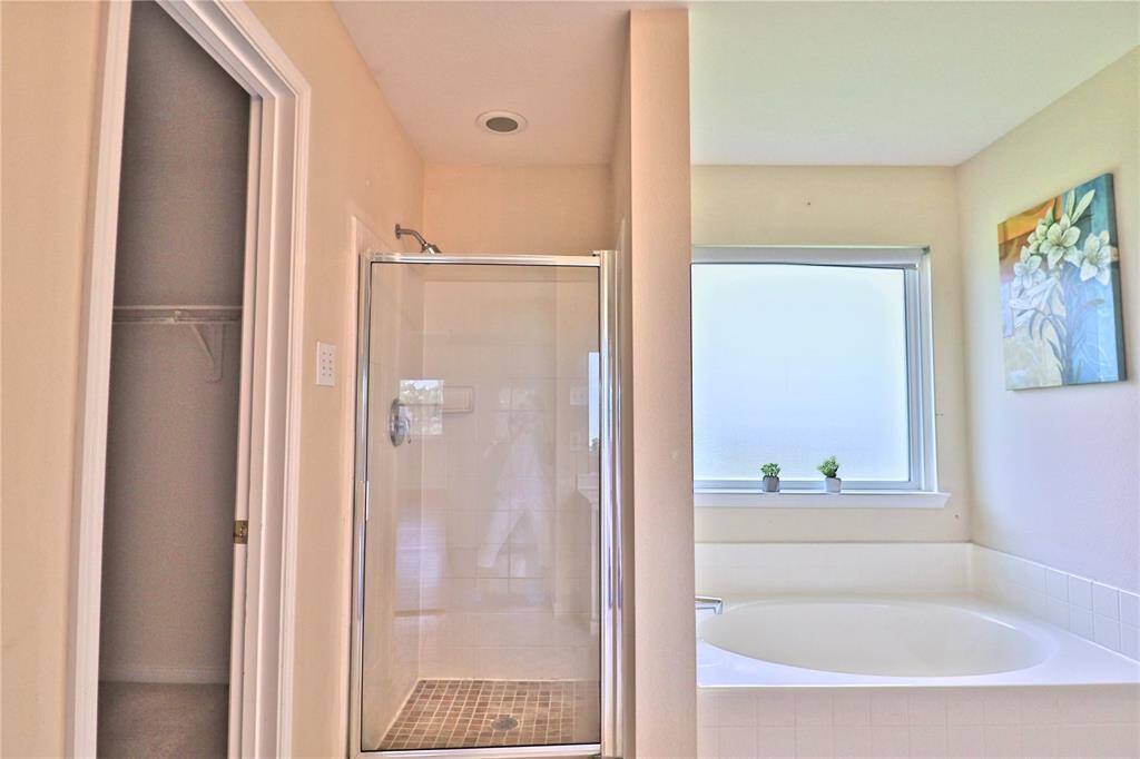 Primary bathroom has a separated shower and tub.