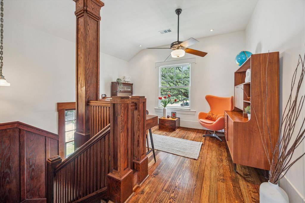 The beautiful full bath on the second floor has a clawfoot tub with shower, bead-board wainscoting, and pedestal sink.