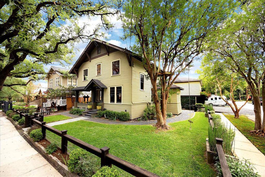The front yard on this corner lot is fully fenced and is shaded by the mature live oak trees that gracefully arch over Bayland Avenue.