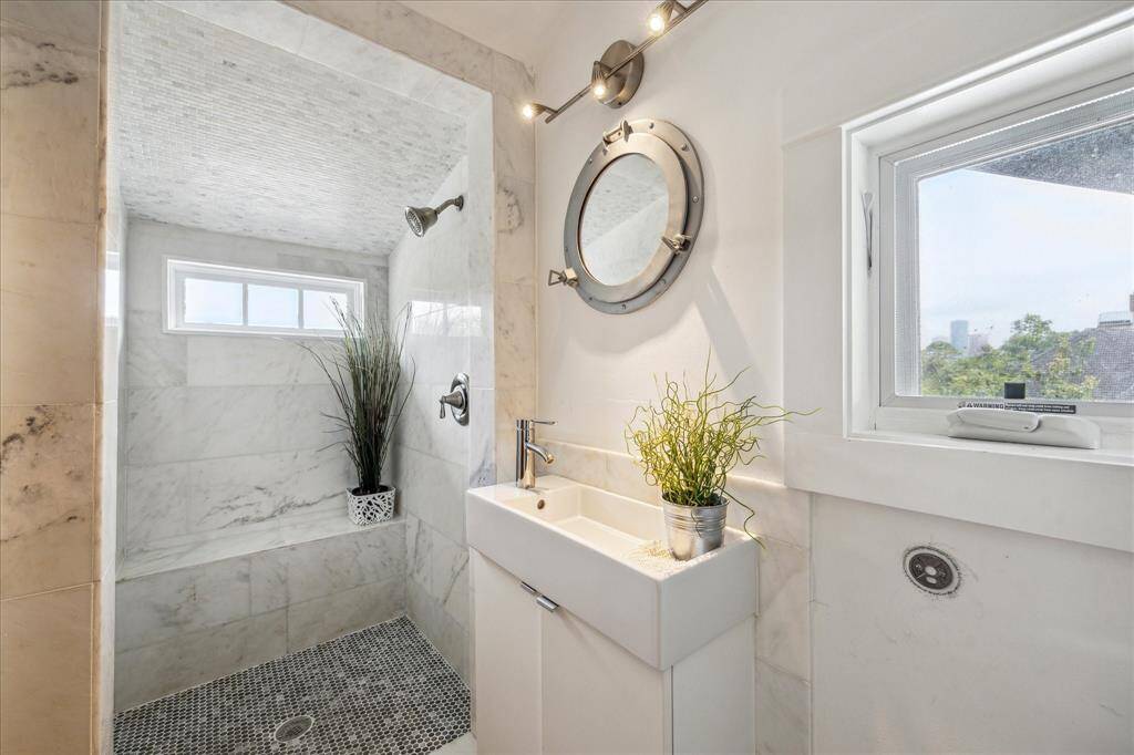 The full bathroom in the garage quarters features a large shower.