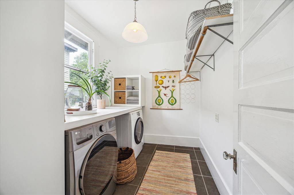 Laundry won’t be a chore in this sunny utility room with convenient hanging space.