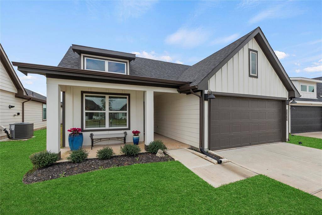 This charming home is a perfect blend of contemporary style and timeless appeal. The spacious front porch offers a welcoming spot to relax, inviting visitors to enjoy the outdoors. The large front window fills the interior with natural light, giving the space a bright and airy feel. Surrounded by lush greenery and thoughtfully placed plants, the landscaping enhances the home’s inviting curb appeal, creating a vibrant and fresh atmosphere.