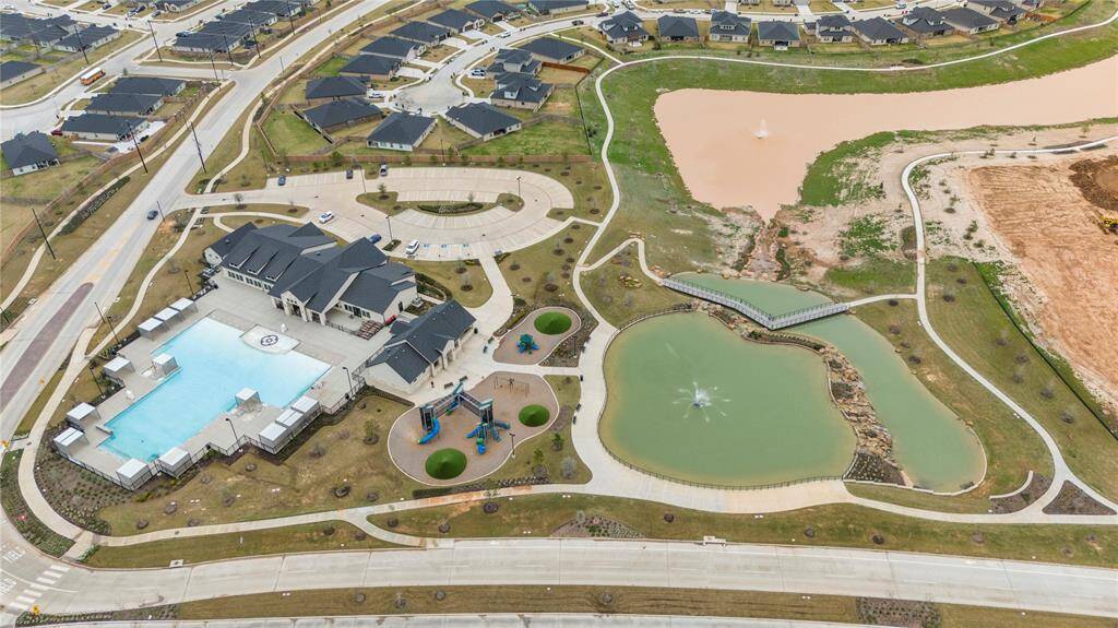 Next to the pool with the gradual depth entrance is another playground, offering a perfect spot for children to enjoy outdoor play while parents can relax nearby. The entire area is beautifully surrounded by a serene lake, adding to the peaceful and scenic atmosphere. The lake enhances the sense of tranquility, providing a stunning backdrop for both the playground and the pool, creating a serene, family-friendly environment where everyone can enjoy both water activities and outdoor fun.