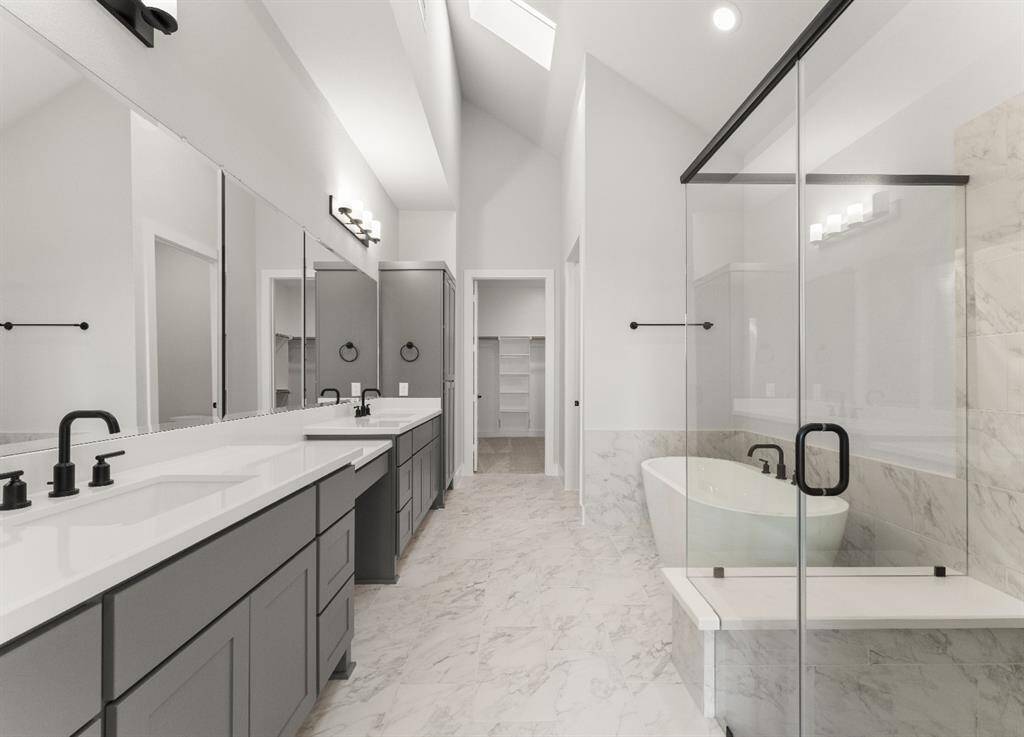 Fabulous Primary Bath with Skylight, Double Sinks, Separate Shower, Freestanding Tub, and Linen Cabinet!