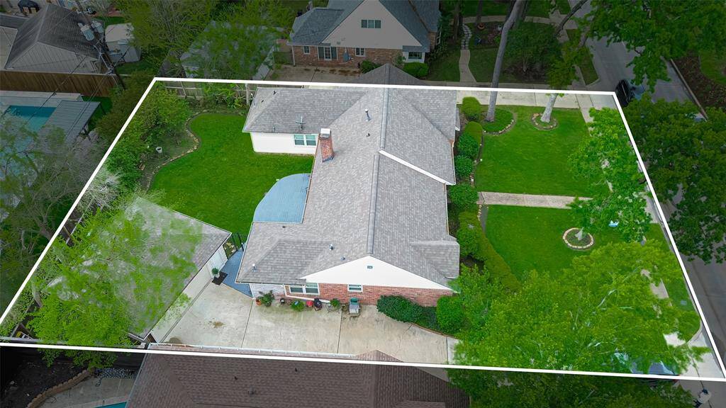 This aerial view highlights a spacious single-story home with a well-maintained yard, driveway, and mature trees. The property is neatly outlined, showing a generous lot size in a suburban neighborhood.