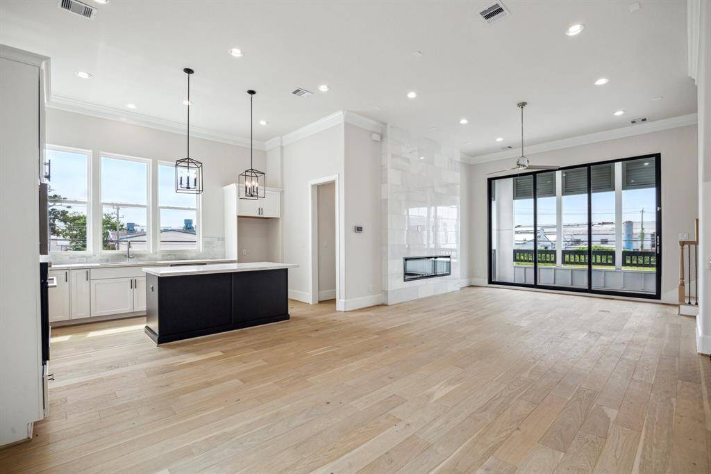 soaring 12ft ceilings with unique open floorplan, gorgeous imperial white marble slab electric fireplace and unobstructed, private open views