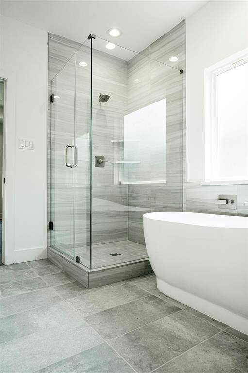 Gorgeous separate shower and tub in primary suite.