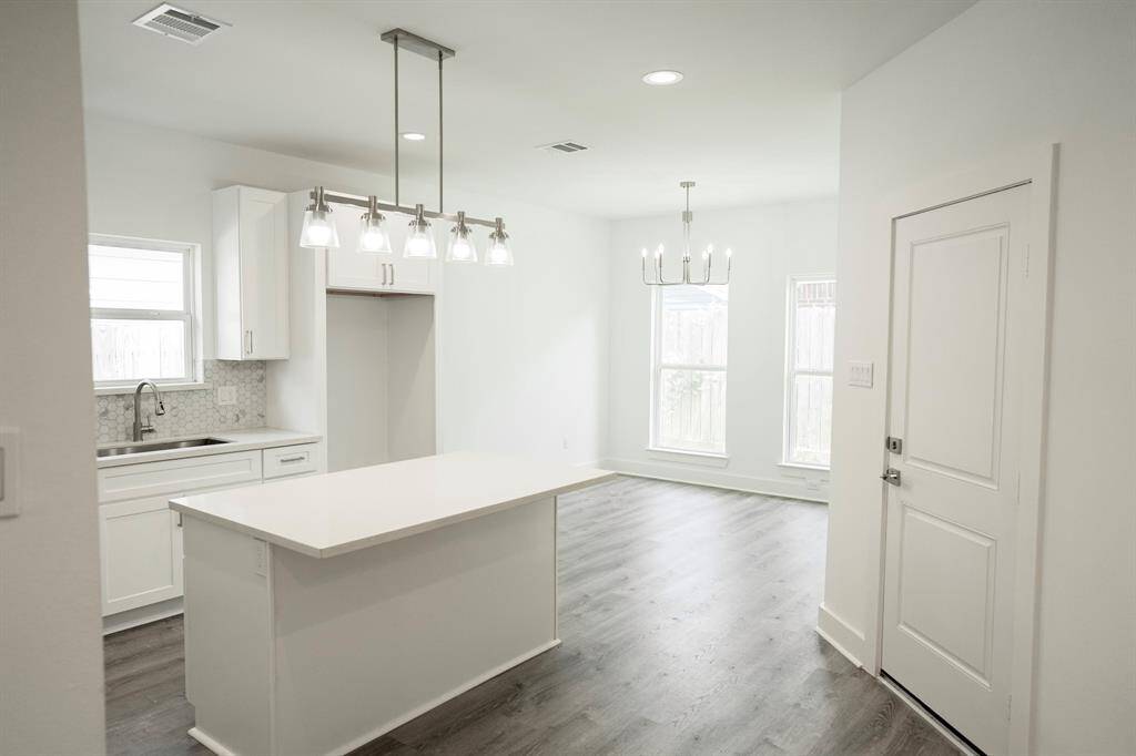 Kitchen with large island and beautiful lighting.