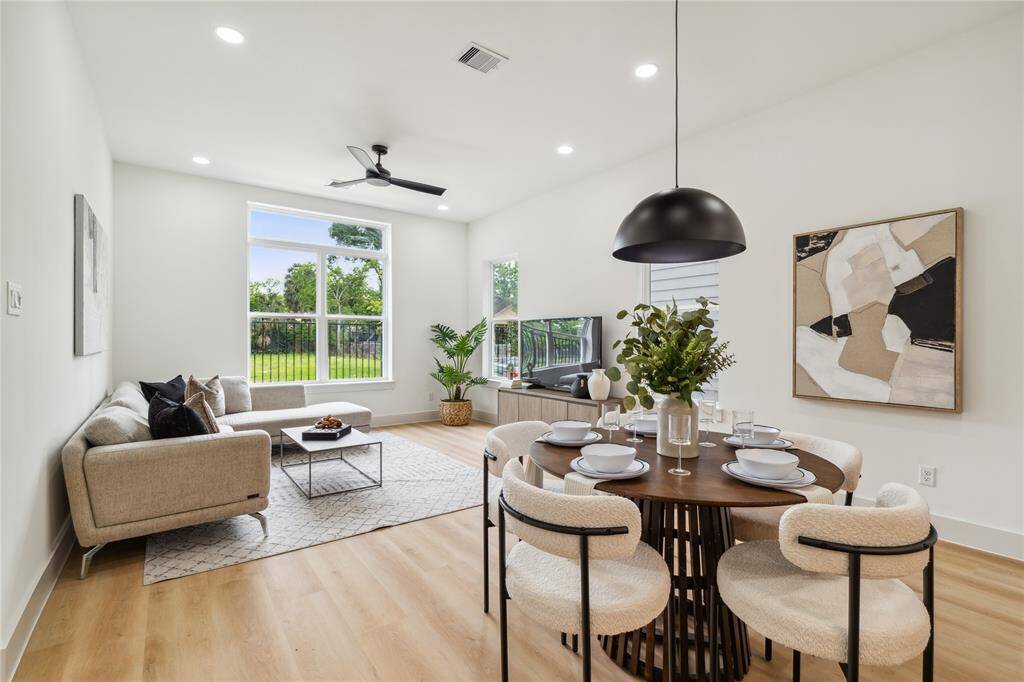 Soaring ceilings, picture windows, and seamless flow between living and dining spaces create an environment that feels spacious, connected, and full of light.