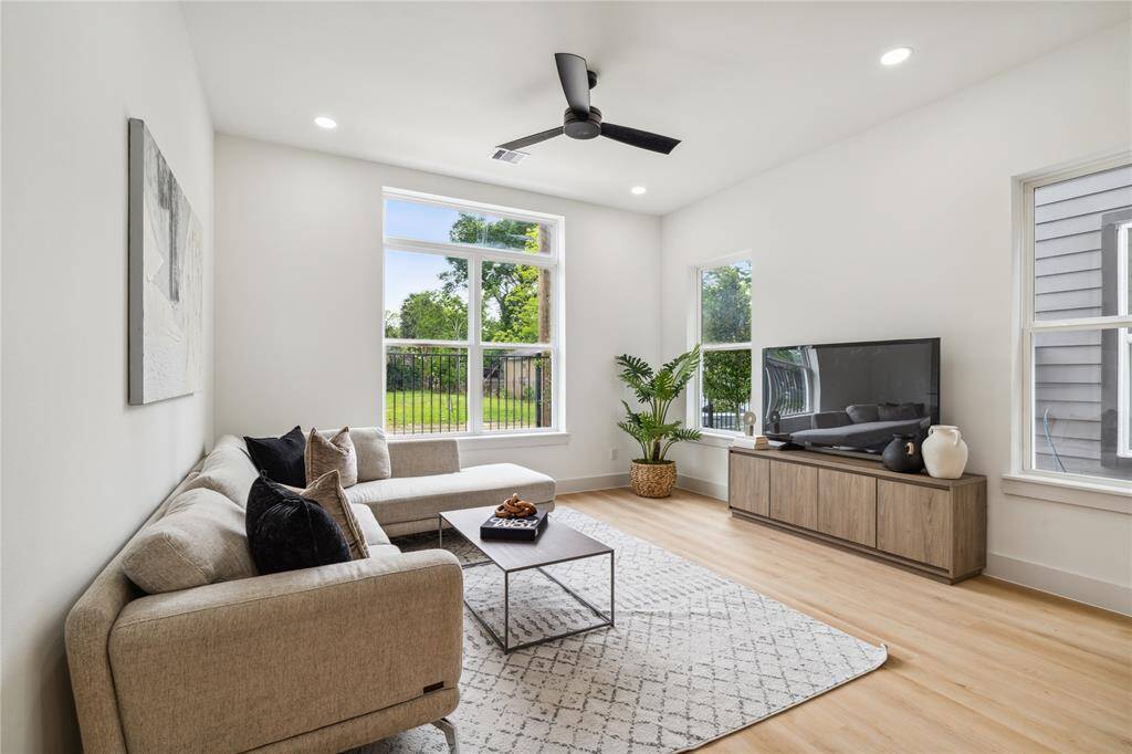 Framed by tall windows and clean lines, the living room delivers natural light and backyard views—bringing comfort and connection into everyday moments.
