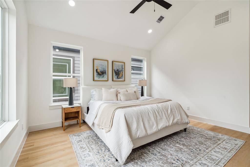 Low-maintenance LVP flooring pairs with generous natural light and a ceiling fan to create a bright, breezy, and energy-efficient retreat.