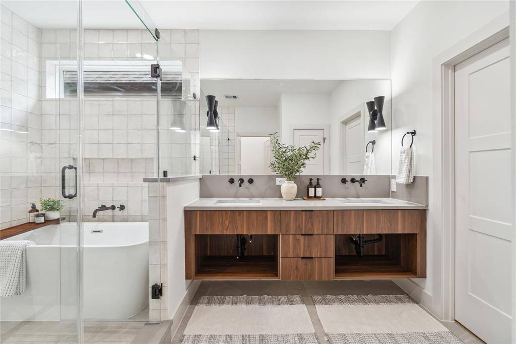 A spa-worthy retreat in your own home—this breathtaking en-suite blends luxury finishes, natural light, and a deep soaking tub for the ultimate place to unwind.
