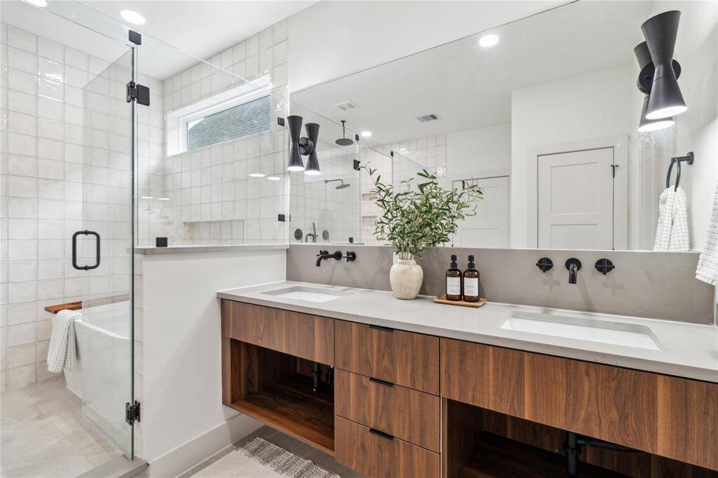 Dual sinks and a sleek floating vanity paired with a full-width mirror make your morning routine feel effortless and elevated.