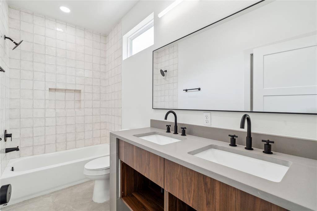Dual sinks in the secondary en suite offer a blend of luxury and everyday ease—perfect for sharing without sacrificing comfort.