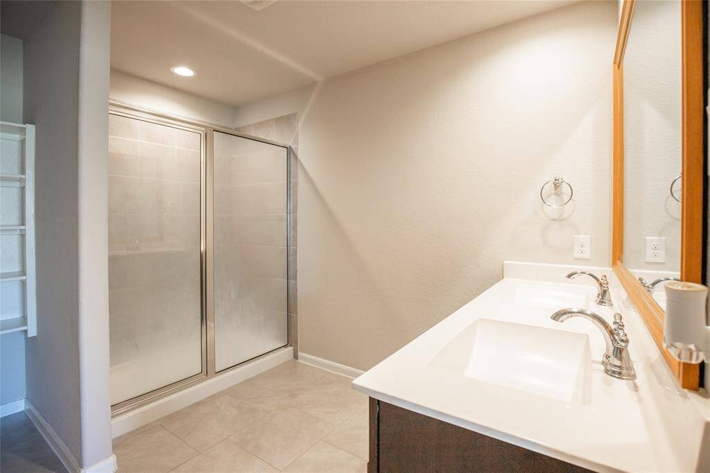 En-suite primary bathroom, offering double-sinks, walk-in shower and walk-in closet.