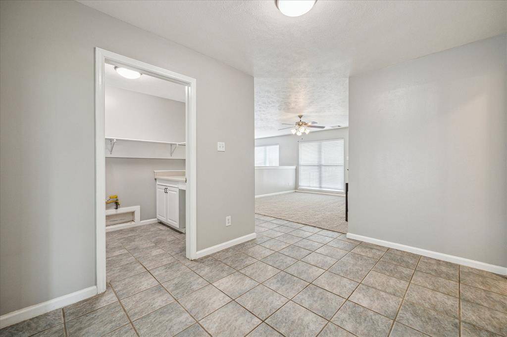 Utility room with W/D connections and added storage.
