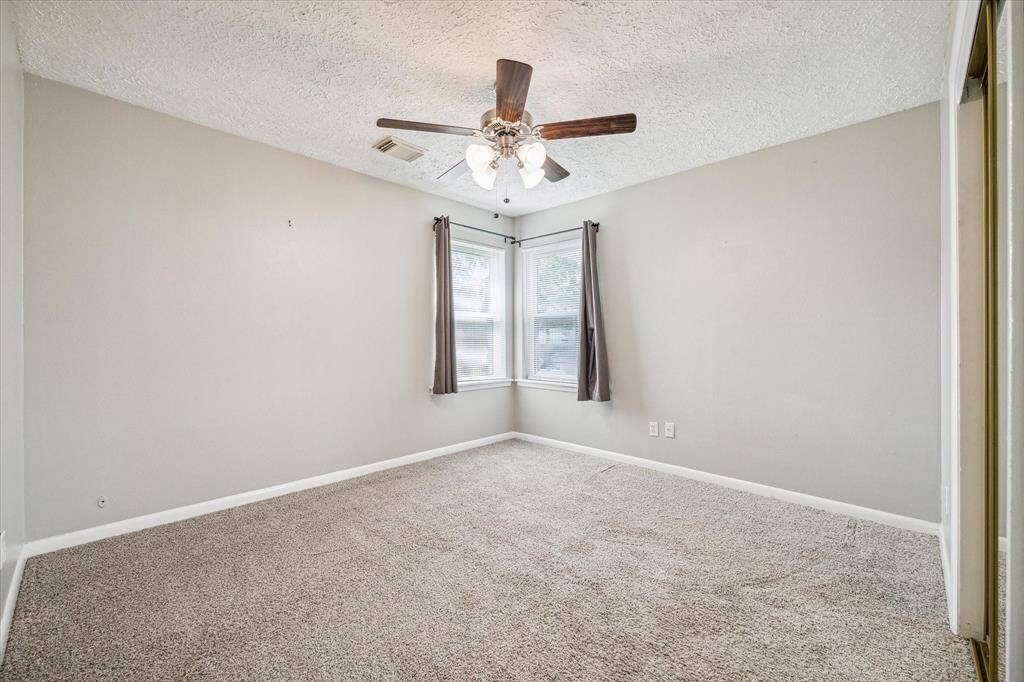 Secondary bedroom with natural light + ceiling fan.