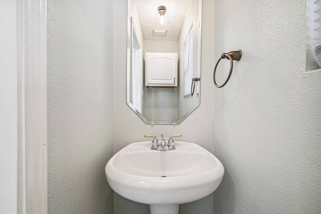 Half bath located conveniently off the kitchen.