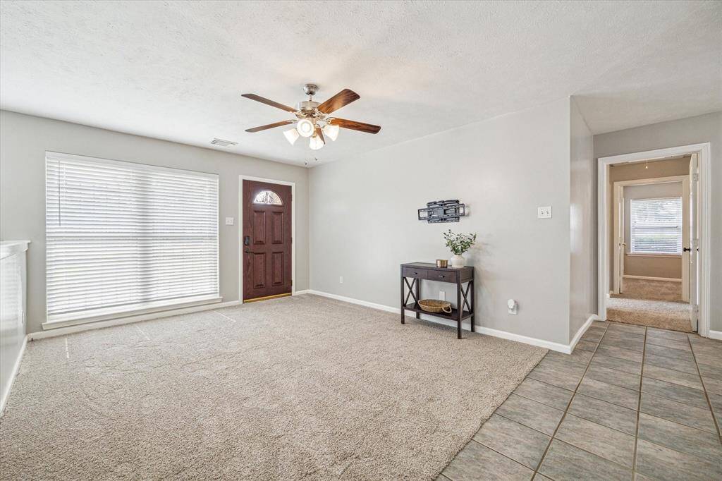 A floor to ceiling window brightens up the space. *TV mount will stay.*