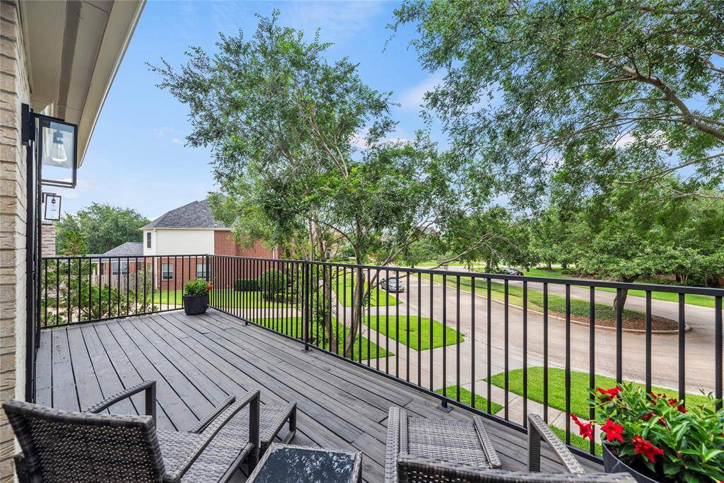 From this vantage on the second-floor balcony, you overlook the gentle curve of the cul-de-sac, where neatly lined homes with manicured lawns form a welcoming semicircle.
