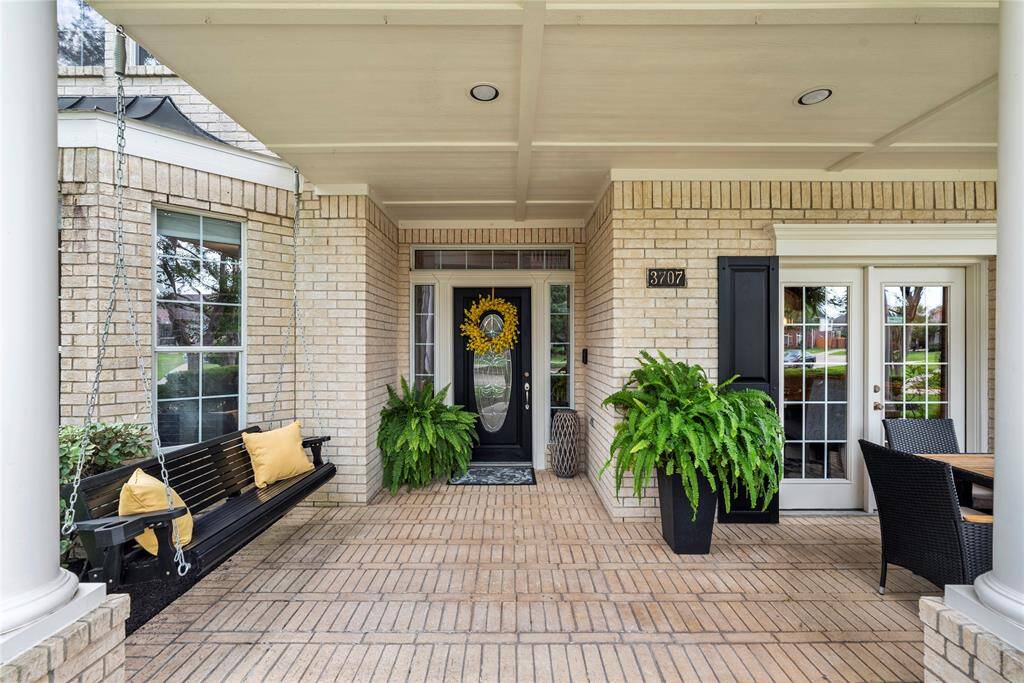 Wonderfully welcoming, the brick paved, covered front porch invites guests to stay awhile.