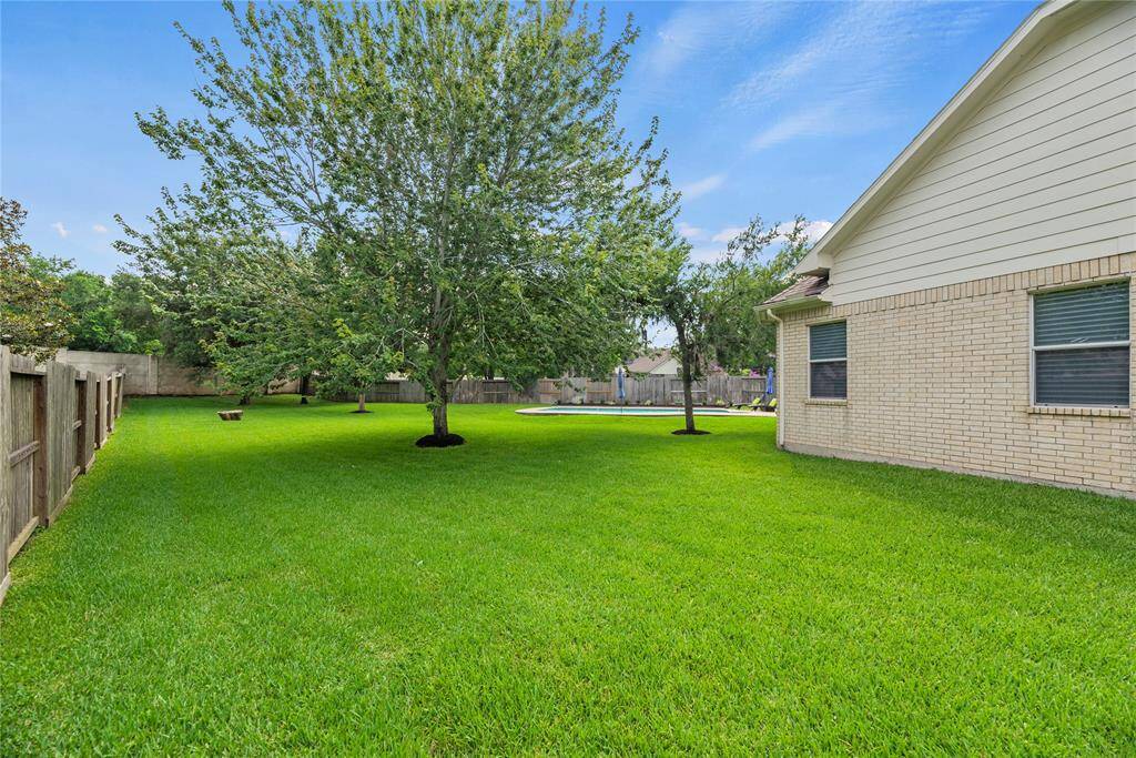 Sprawling emerald-green grass adorns this meticulously manicured lawn. Completely level, this 0.44 acre-lot offers an ideal space for gardening, playing, and gathering.