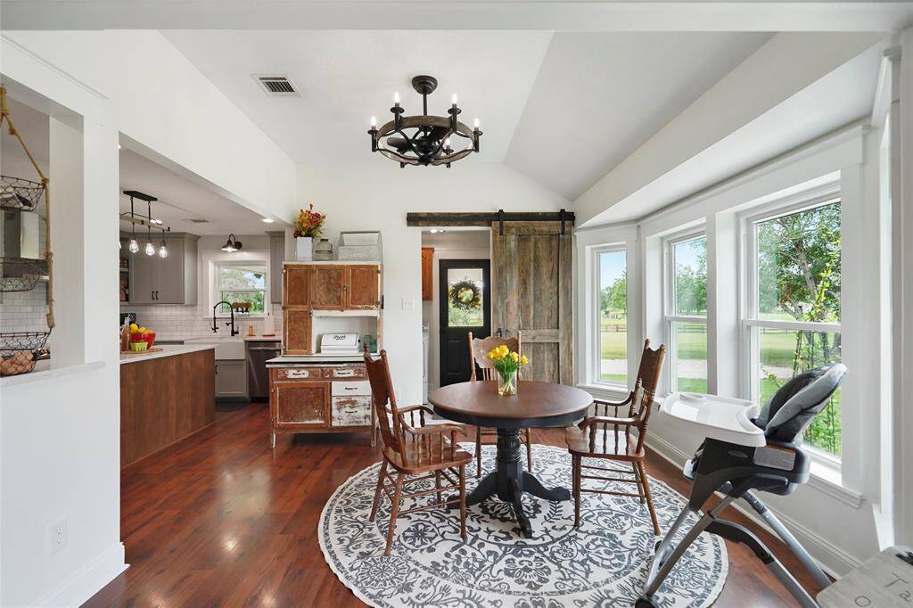 Start your mornings here—surrounded by windows and tranquil pasture views from the cozy, window-lined breakfast area.