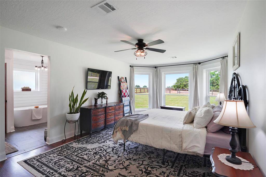 Spacious and sunlit, the primary suite features a beautiful bay window overlooking the backyard—perfect for peaceful mornings and afternoon light.