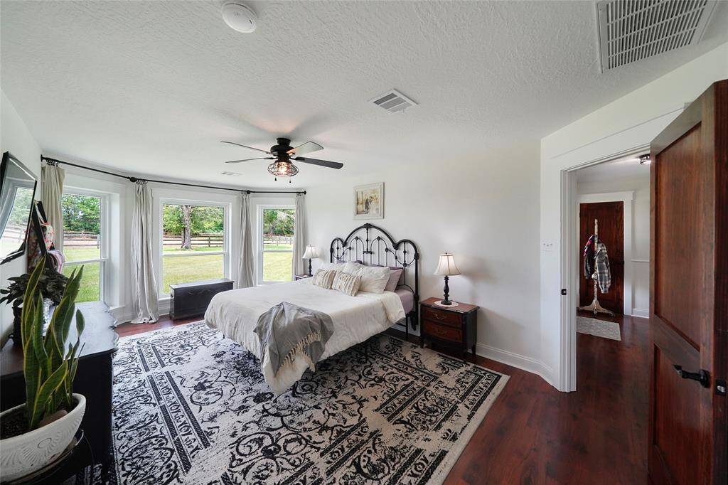 This angle shows the room’s generous layout with easy access to the en-suite bath and a calm, cohesive design.