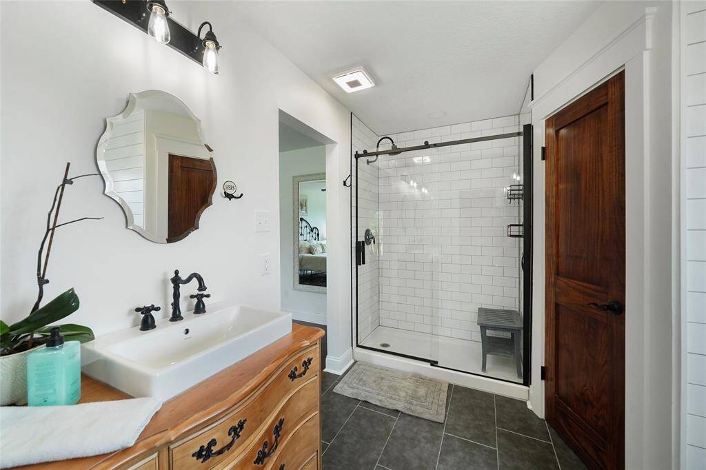 Enjoy the walk-in glass shower, dual vanities, and updated fixtures—blending vintage style with everyday function.
