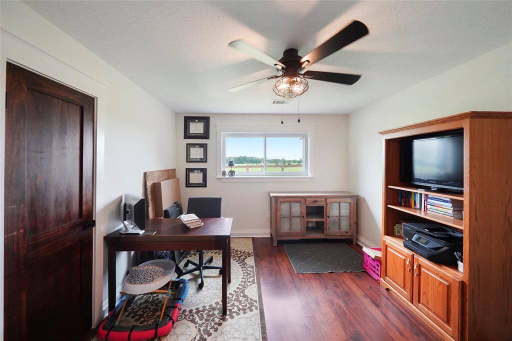 This flexible room is ready to serve as a home office, study, or additional bedroom—complete with a window overlooking the back acreage.