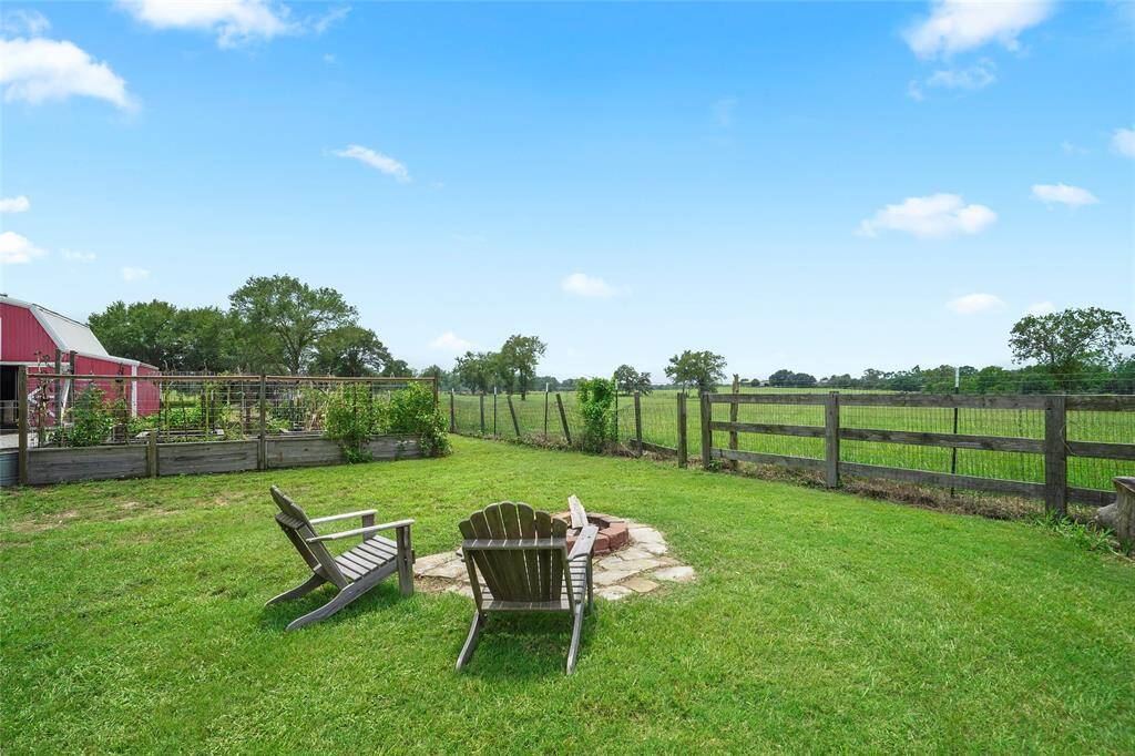 A quiet corner for marshmallow roasts or peaceful evenings—this fire pit and raised garden beds make outdoor time extra special.