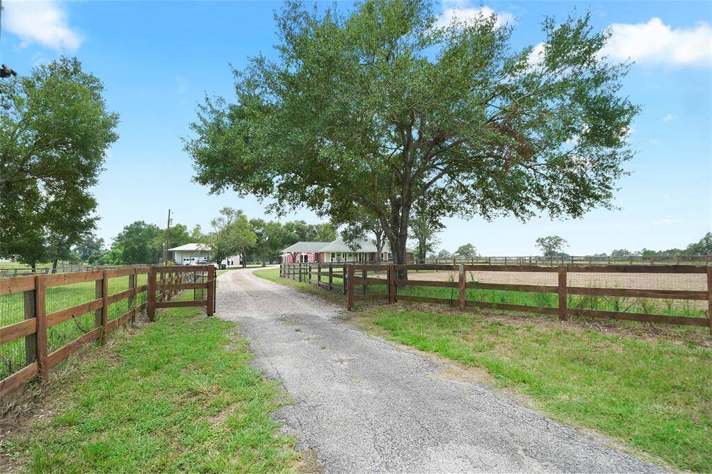 Gated entry and crushed limestone driveway set the tone for the peaceful, fully fenced 9+ acre property.