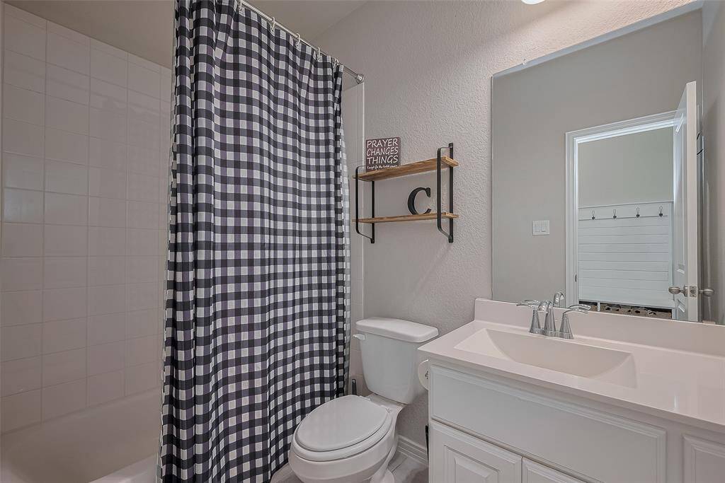The full bath downstairs conveniently serves both guests and the main-floor secondary bedroom