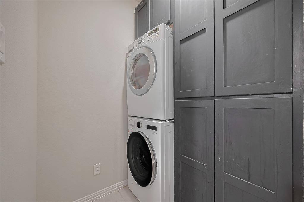 The laundry room features custom cabinetry for extra storage and organization, and the washer and dryer are included with the home. Not pictured is a charming custom barn door that adds both style and function to the space