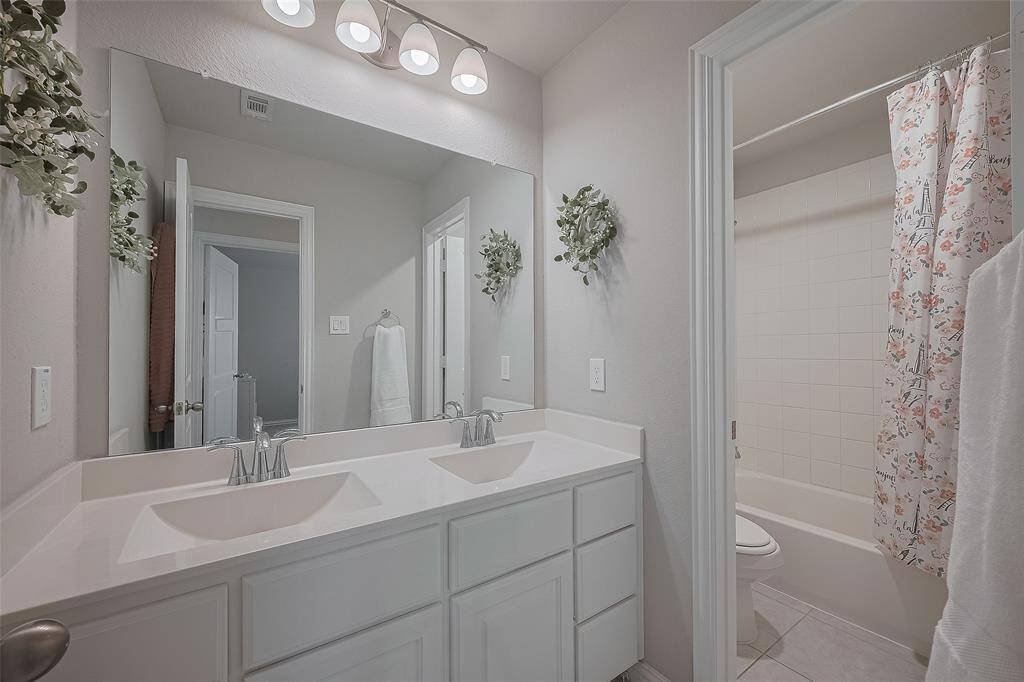 Full bath upstairs with double sinks and private shower area
