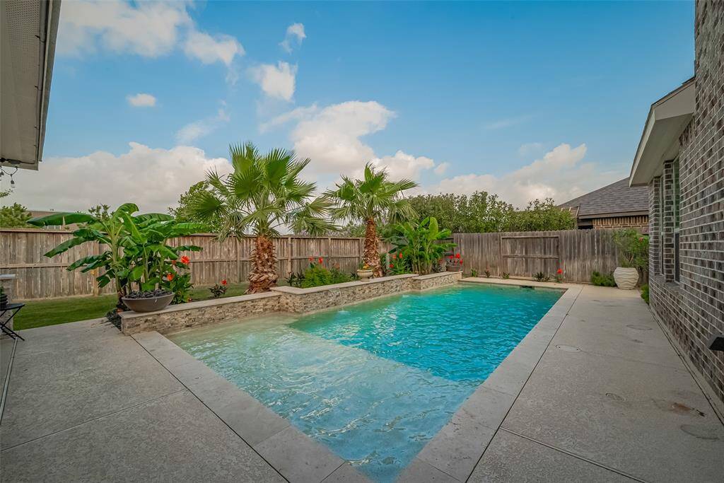 The heated, chlorinated pool has a large sun ledge, premium color pool lighting and 2 fire bowls